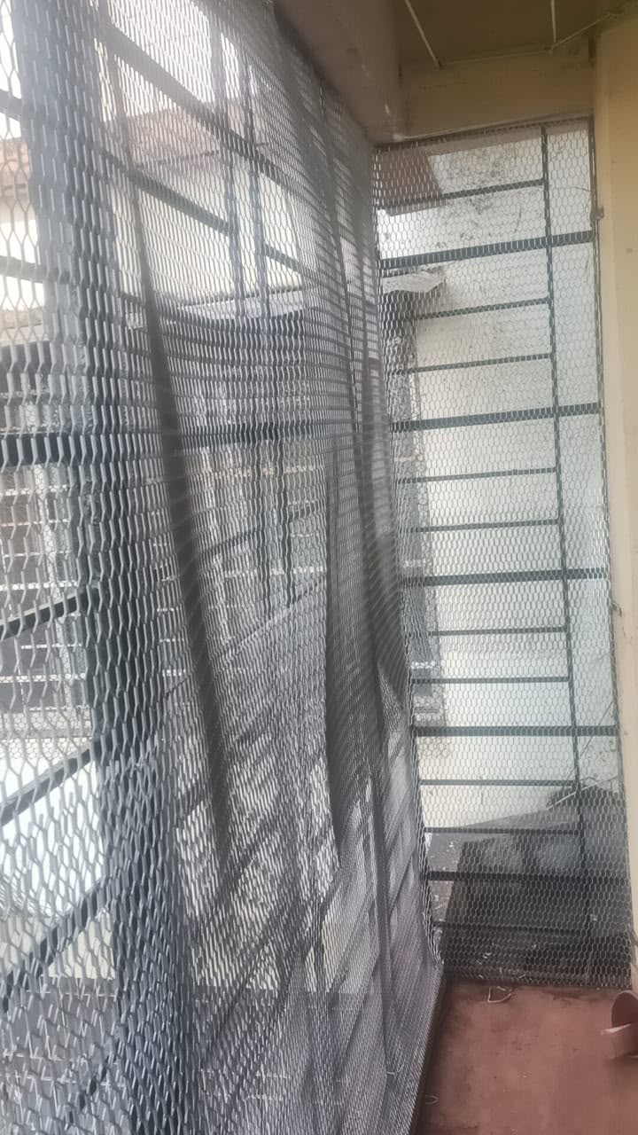 Invisible grill installation on a balcony